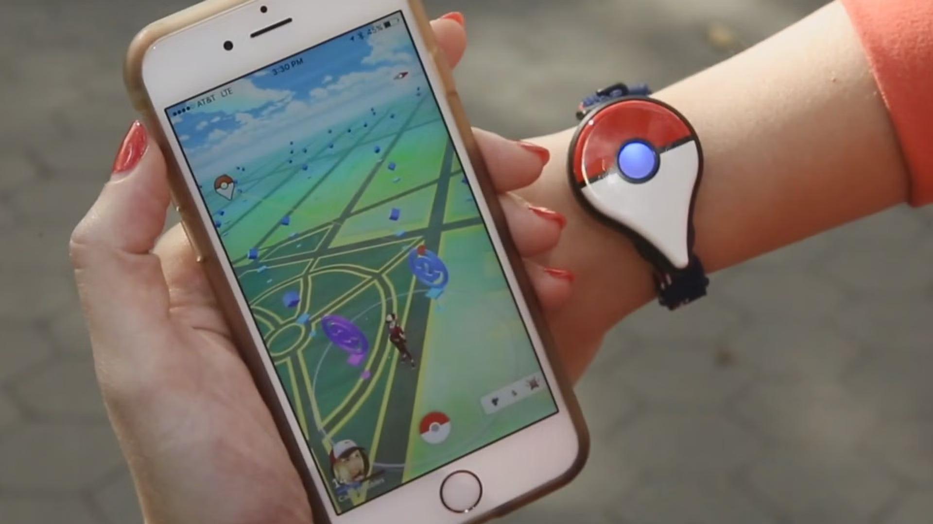 'Pokémon GO' Plus accessory on the wrist of a player. 