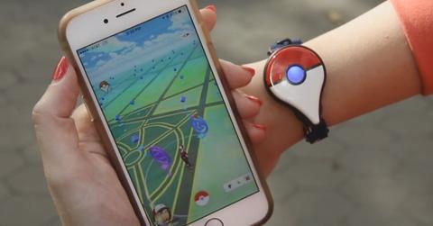 'Pokémon GO' Plus accessory on the wrist of a player.