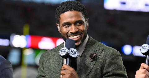 Reggie Bush speaking at a sports event in 2023