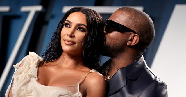 Kanye West whispers in Kim Kardashian's ear at 2020 Vanity Fair Oscar Party.
