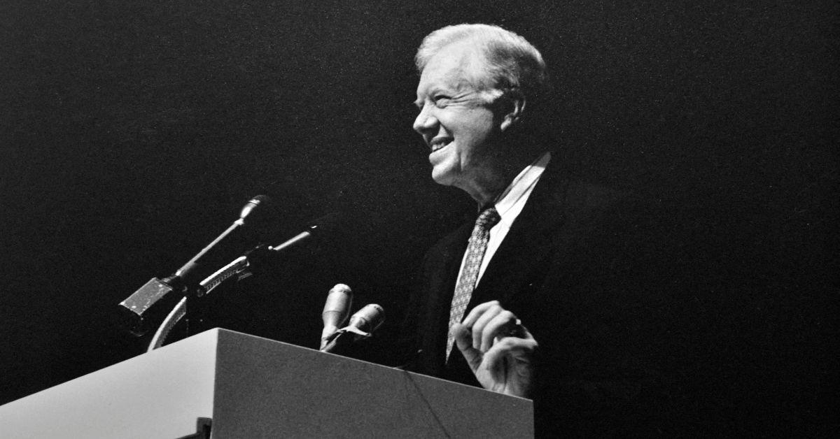 Jimmy Carter speaking at a podium at a book event. 