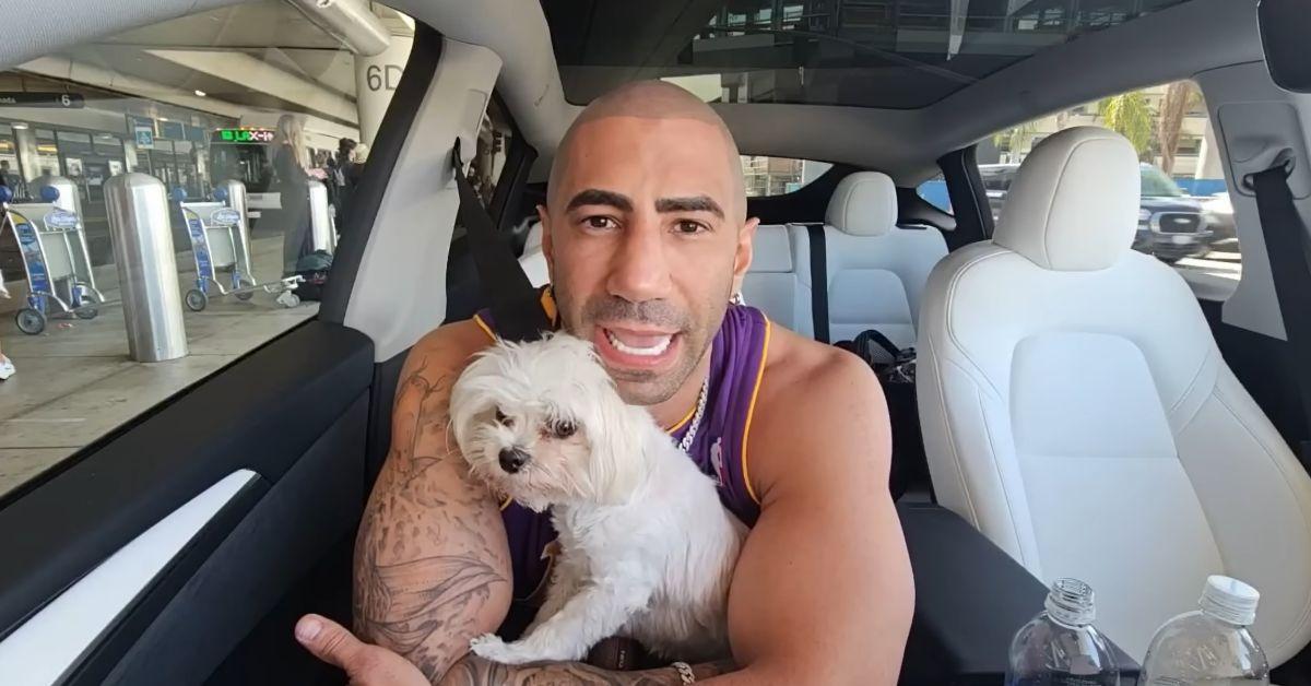 Fousey in a car with a small dog.