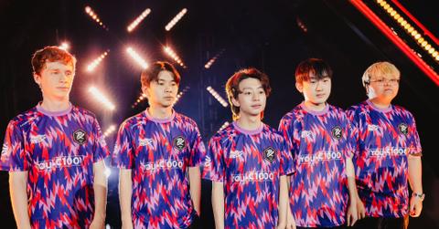 Paper Rex team taking a picture on stage at a 'Valorant' tournmanet.