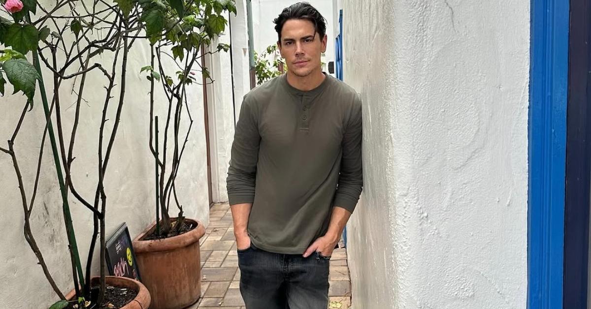 Tom Sandoval leans against a wall