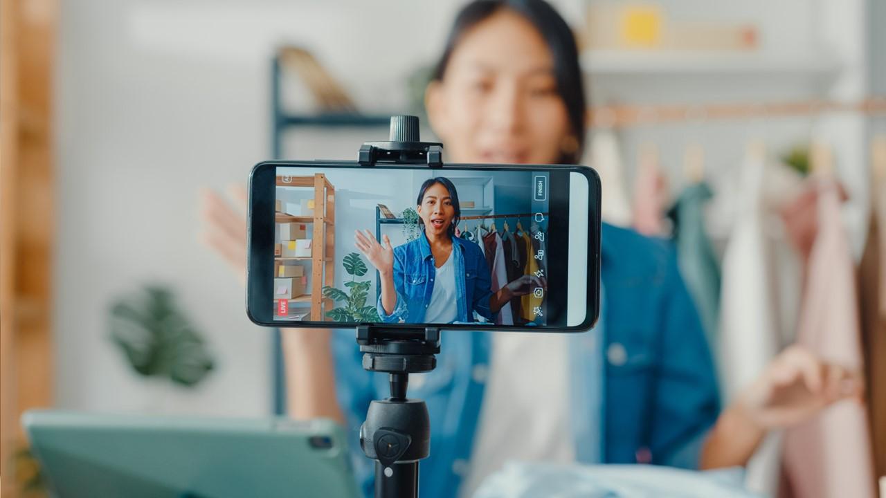 A woman filming a TikTok video