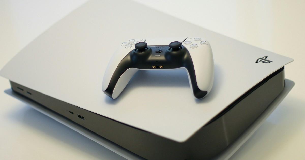 A PS5 with a controller sitting on it 