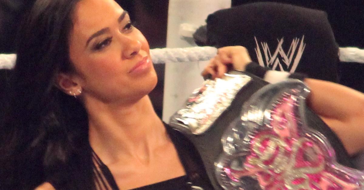 AJ Lee holding a wrestling belt