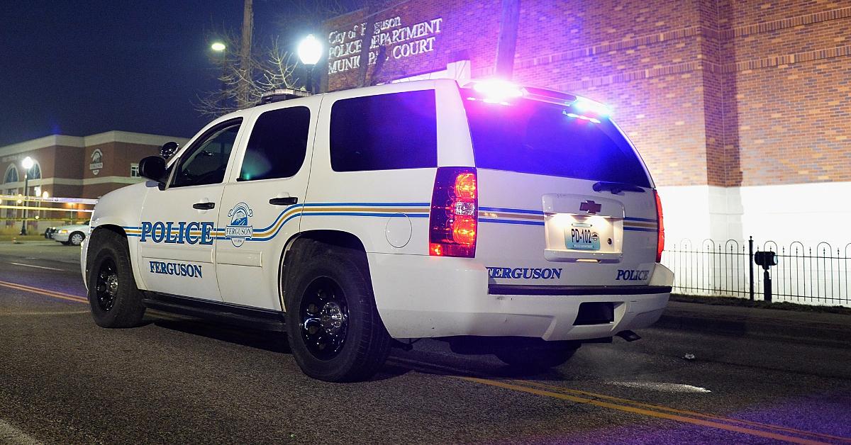 Police Officer Touching Back Of Vehicle