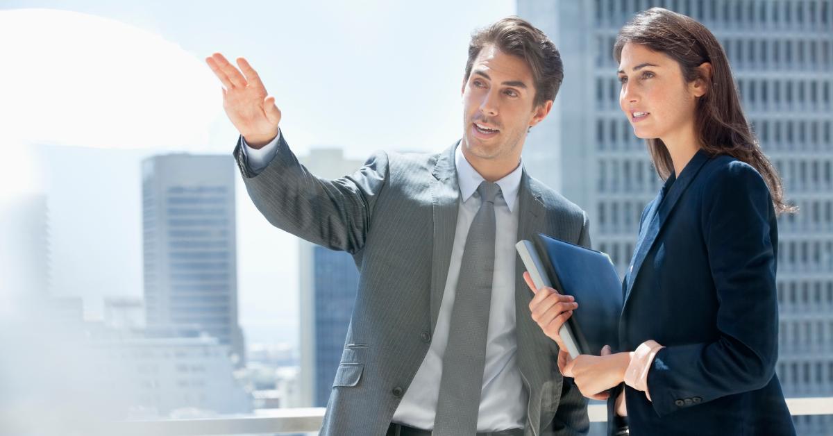 A man explaining something to his female co-worker.