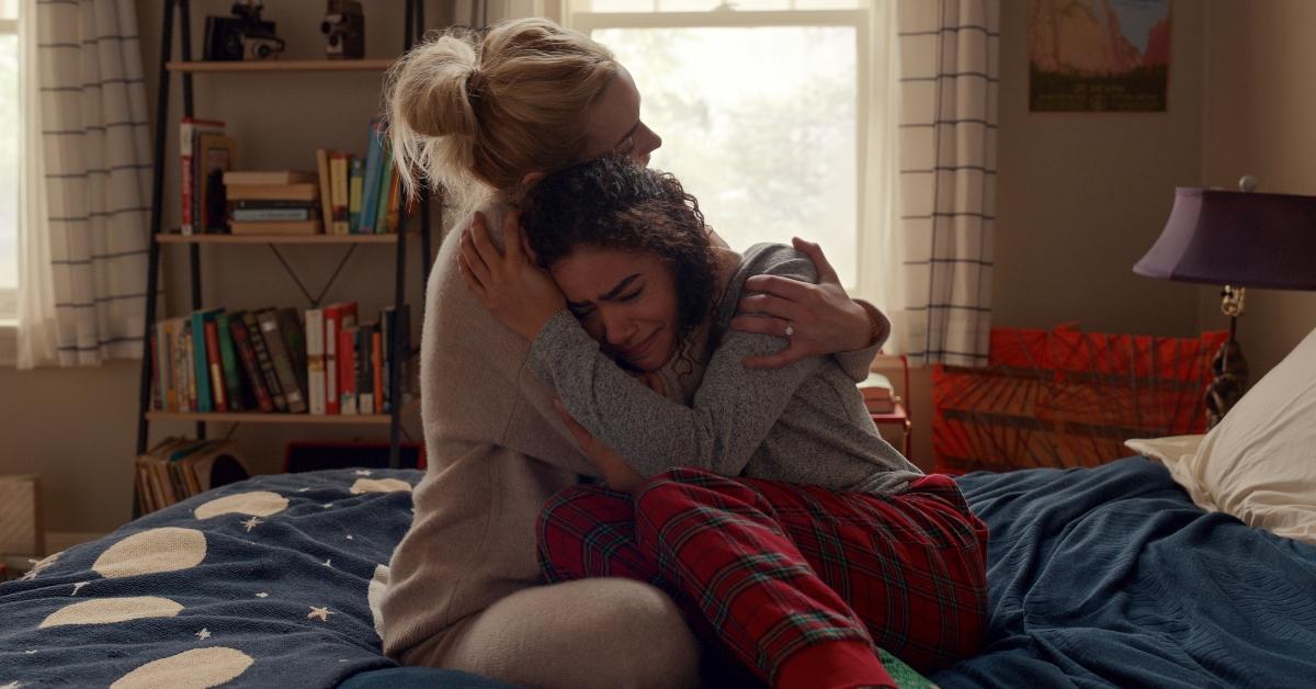 Brianne Howey as Georgia holding actress Antonia Gentry as Ginny while she cries in Netflix's Ginny and Georgia.