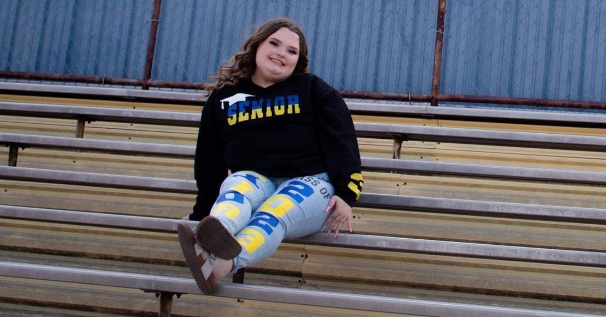 Alana Thompson sits on high school bleachers