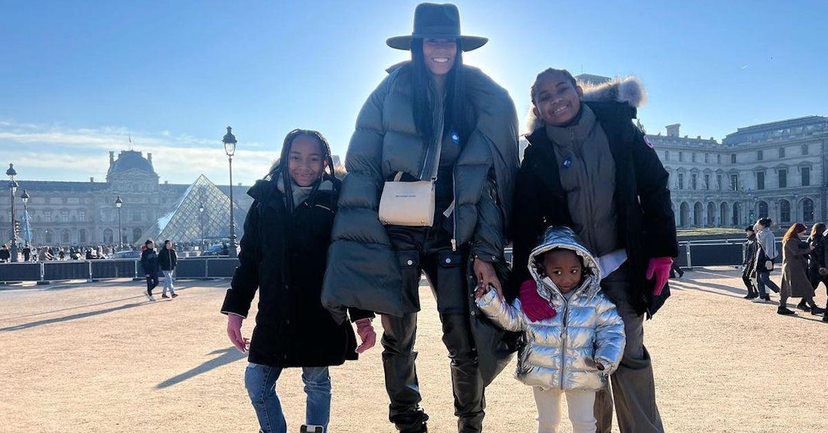 Kiara standing with three of their four kids in Paris.