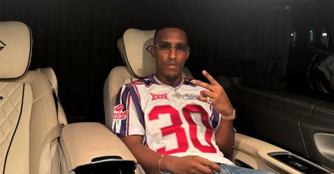 Yung Filly in a car flashing a peace sign.