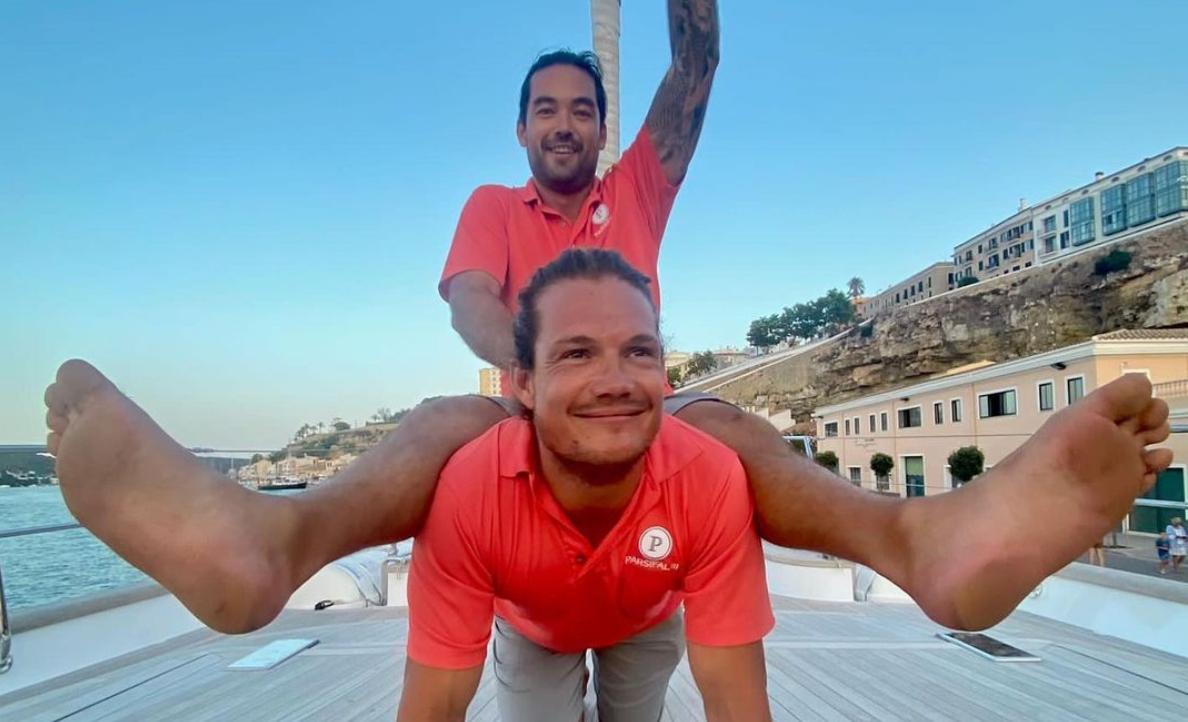 Colin and Gary mess around on a boat deck behind the scenes of Below Deck Sailing Yacht