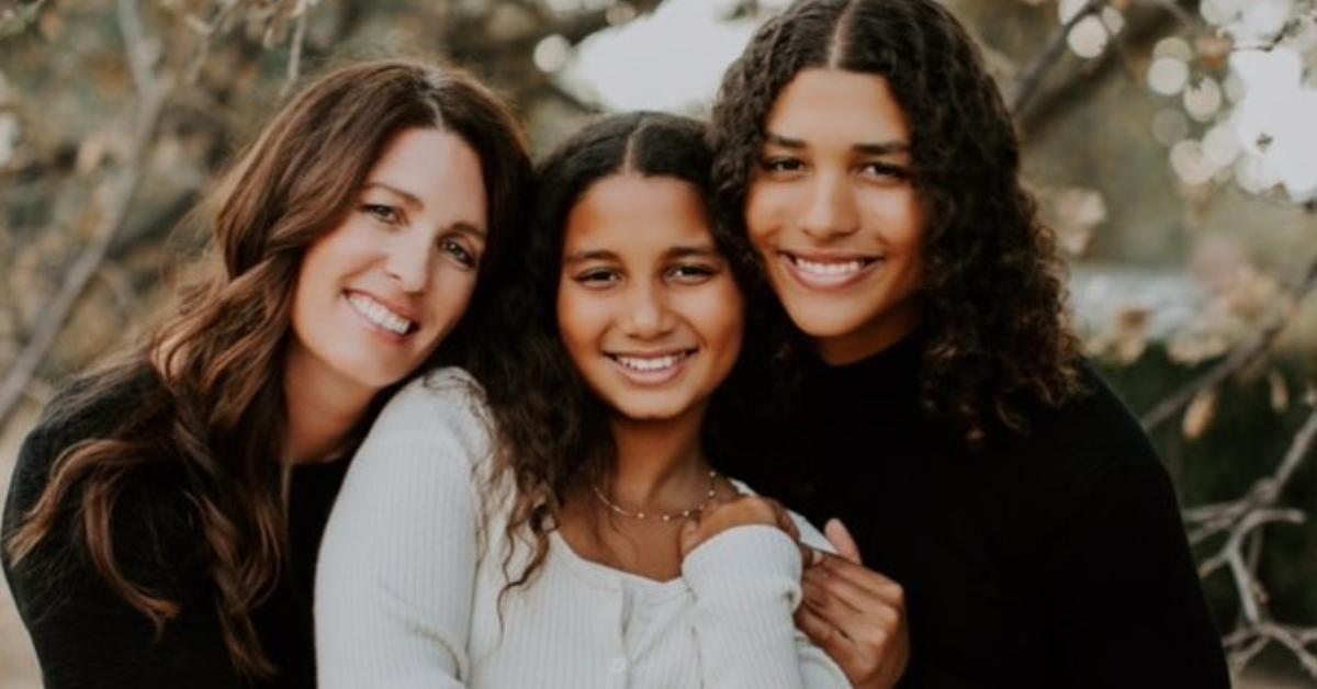 Maya Brady with her mom and younger sister outside in the fall.