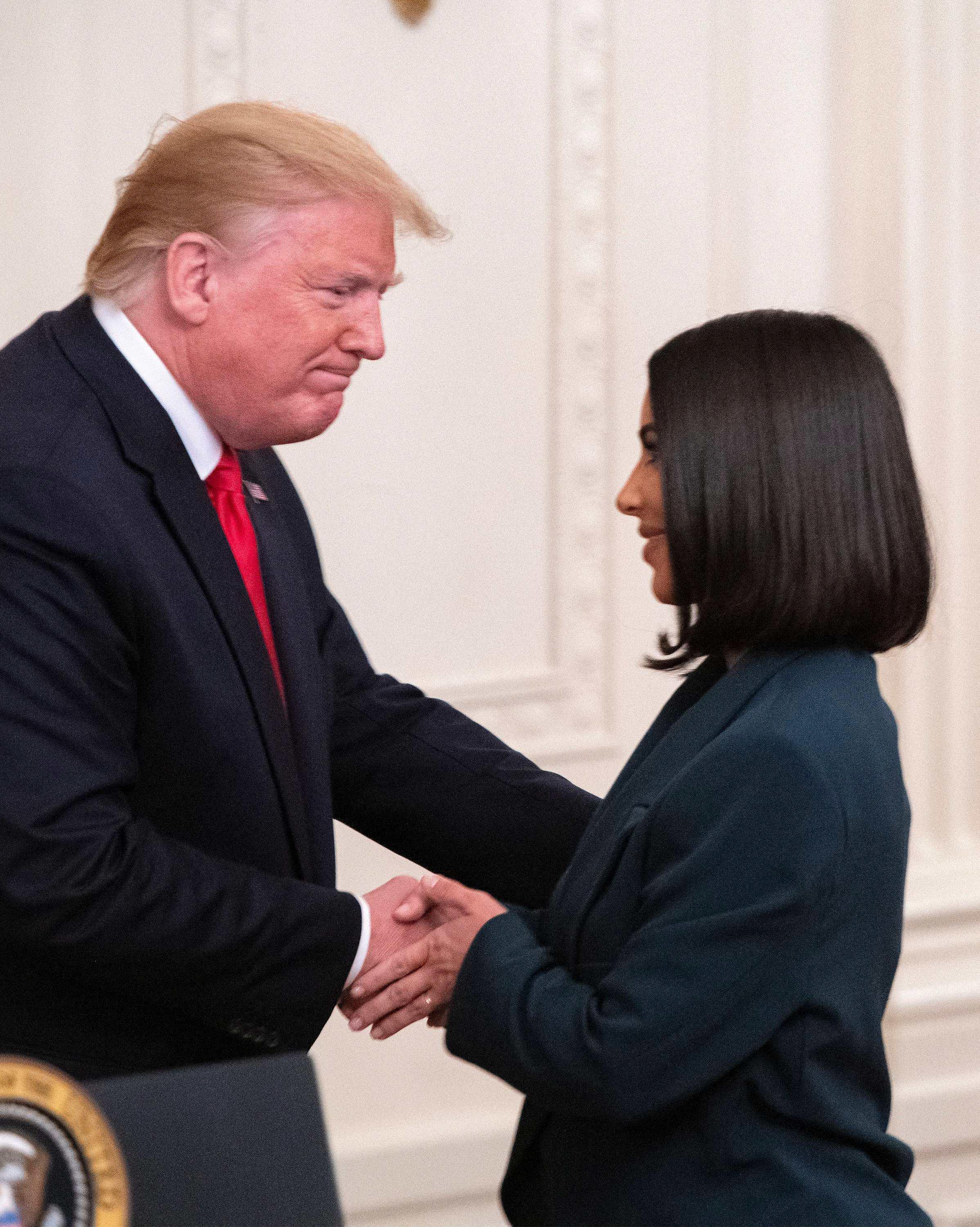 Kim Kardashian shaking Donald Trump's hand.