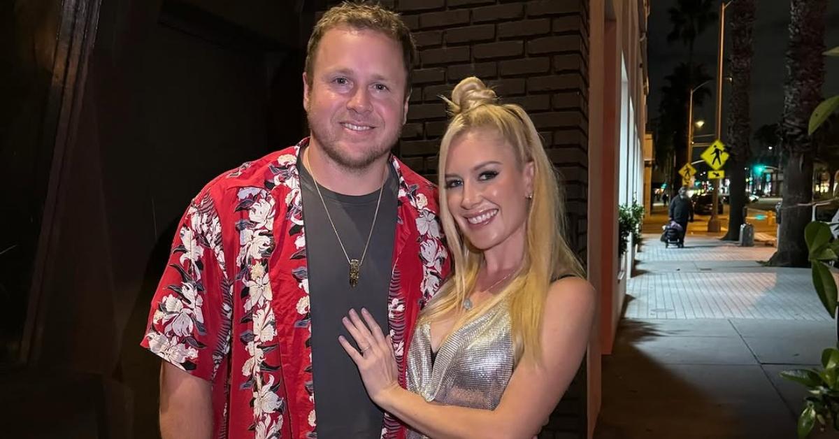 Spencer Pratt and Heidi Montag stand outside together in a Hawaiian shirt and silver top