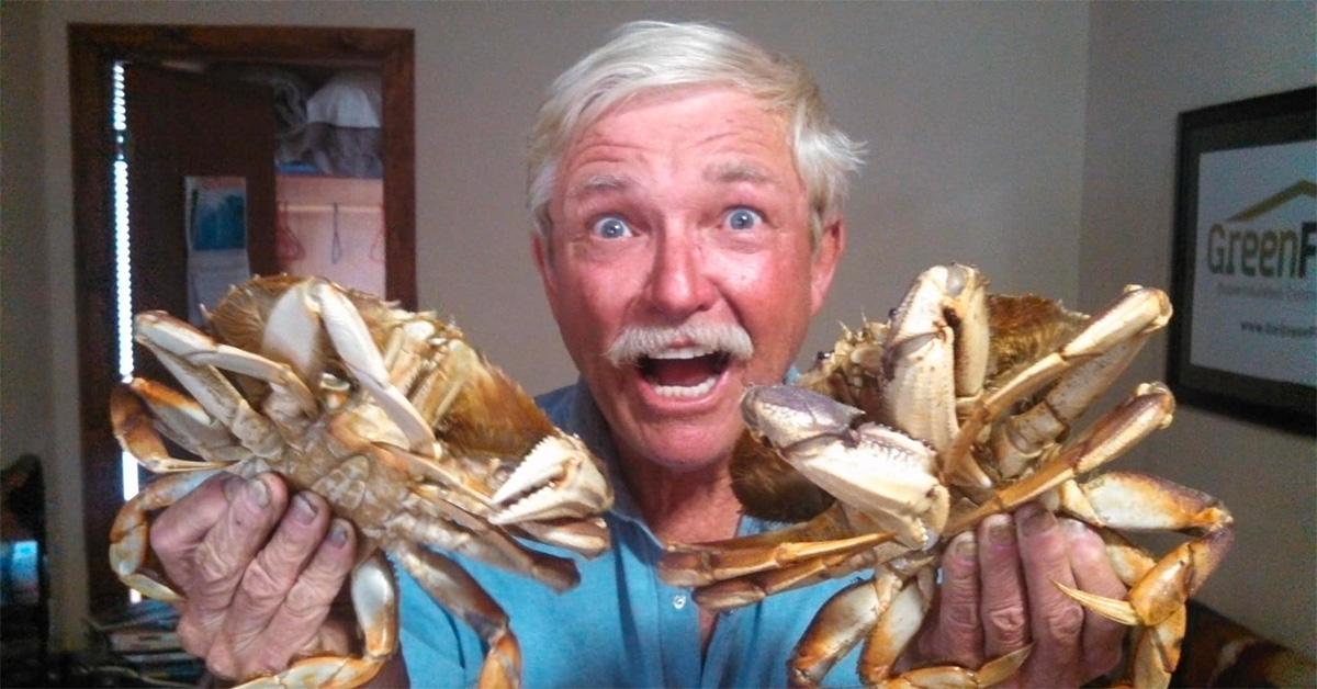 'Dakota' Fred Hurt holding crabs with his mouth hanging open. 