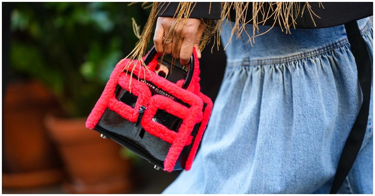 A person walking with a Brandon Blackwood purse