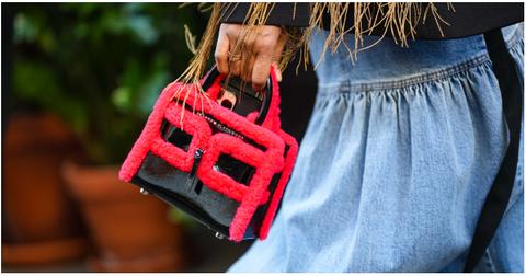 A person walking with a Brandon Blackwood purse