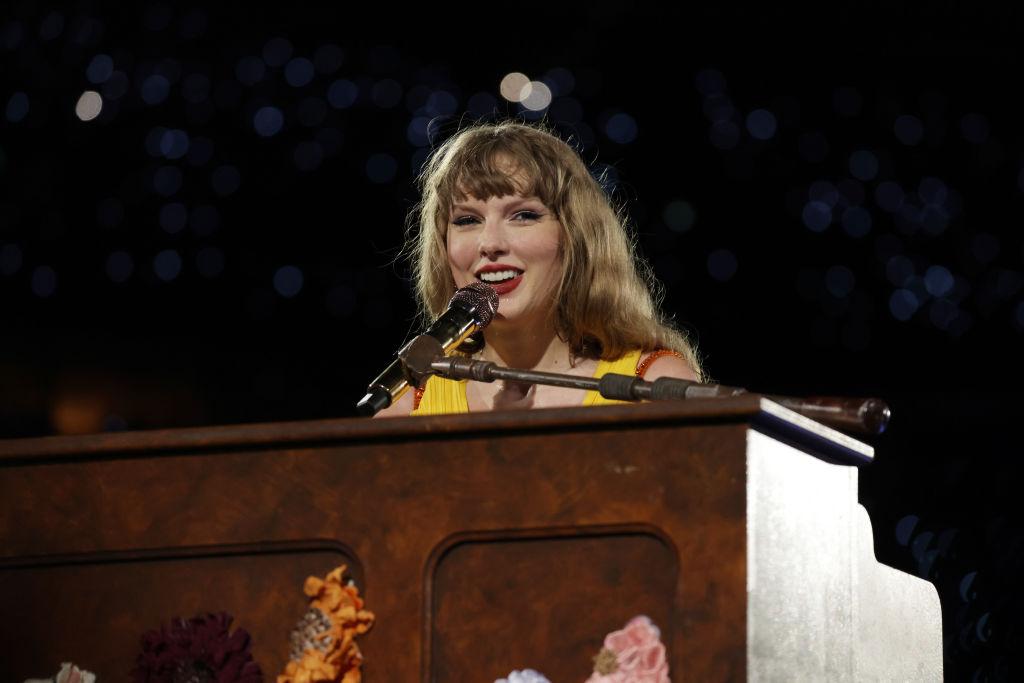 Taylor Swift wearing the yellow dress while performing surprise songs