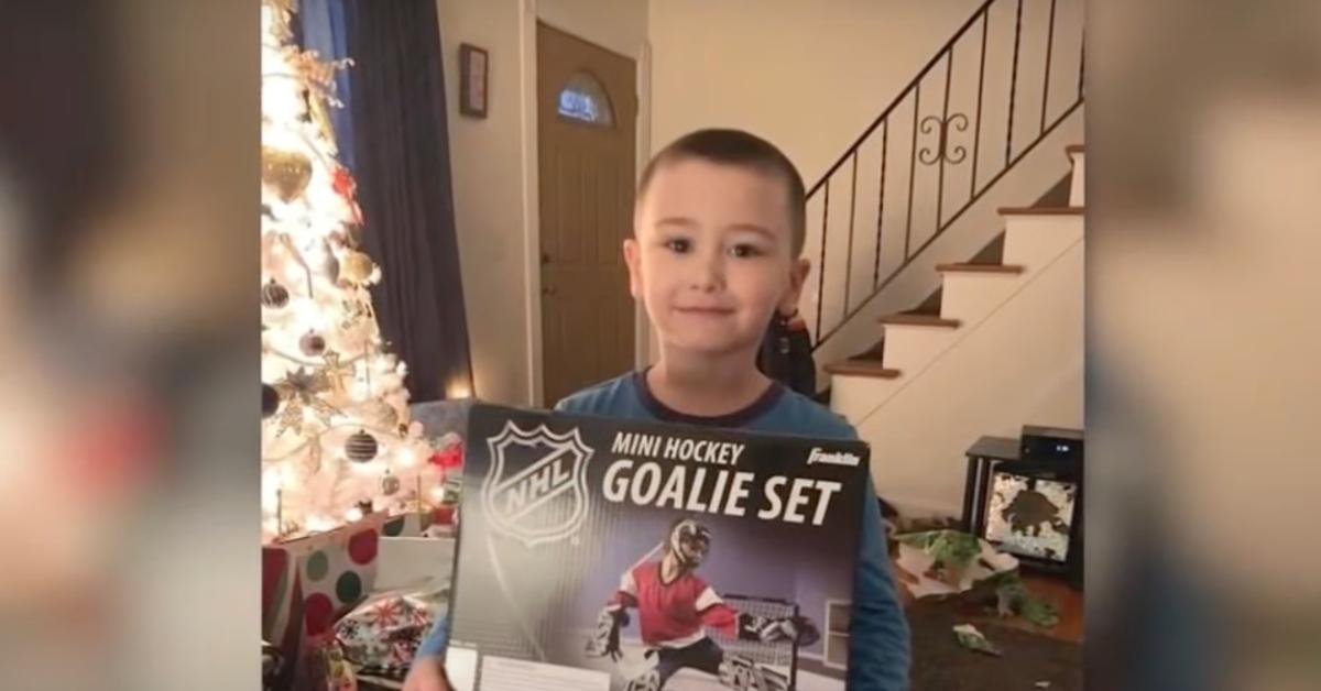 Corey Micciolo holds up a mini hockey goalie set game