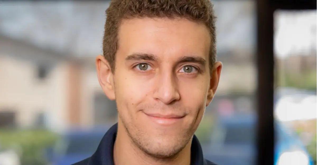 Daniel Naroditsky smiling in a collared shirt.