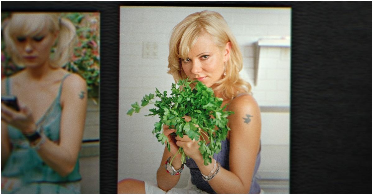 Sarma Melngailis holding a plant and posing with her arm tattoo. 