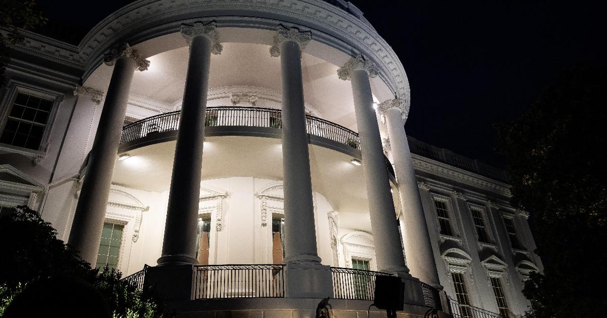 The White House is photographed at night.