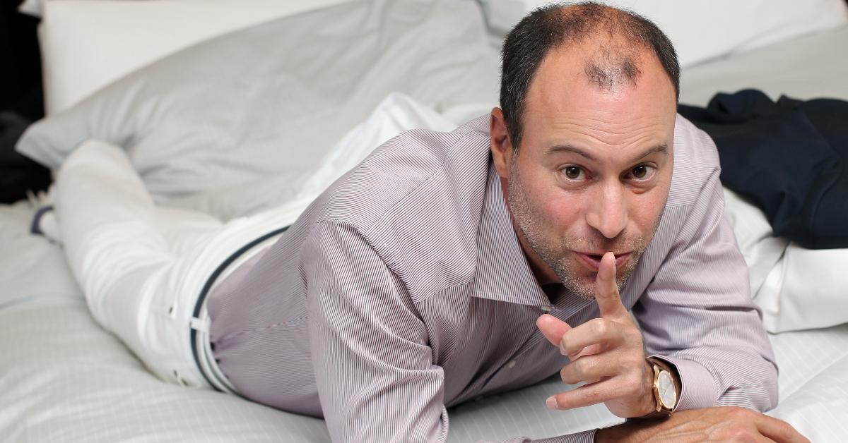 Ashley Madison CEO Noel Biderman lays in bed shushing 