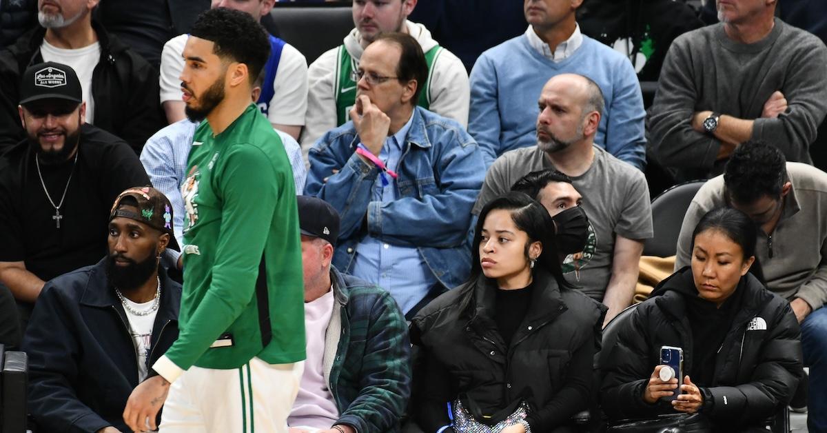 Ella Mai at a Celtics game with Jayson Tatum walking past (2019)