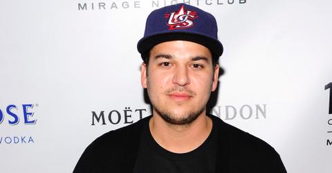 Rob Kardashian smiling wearing a hat