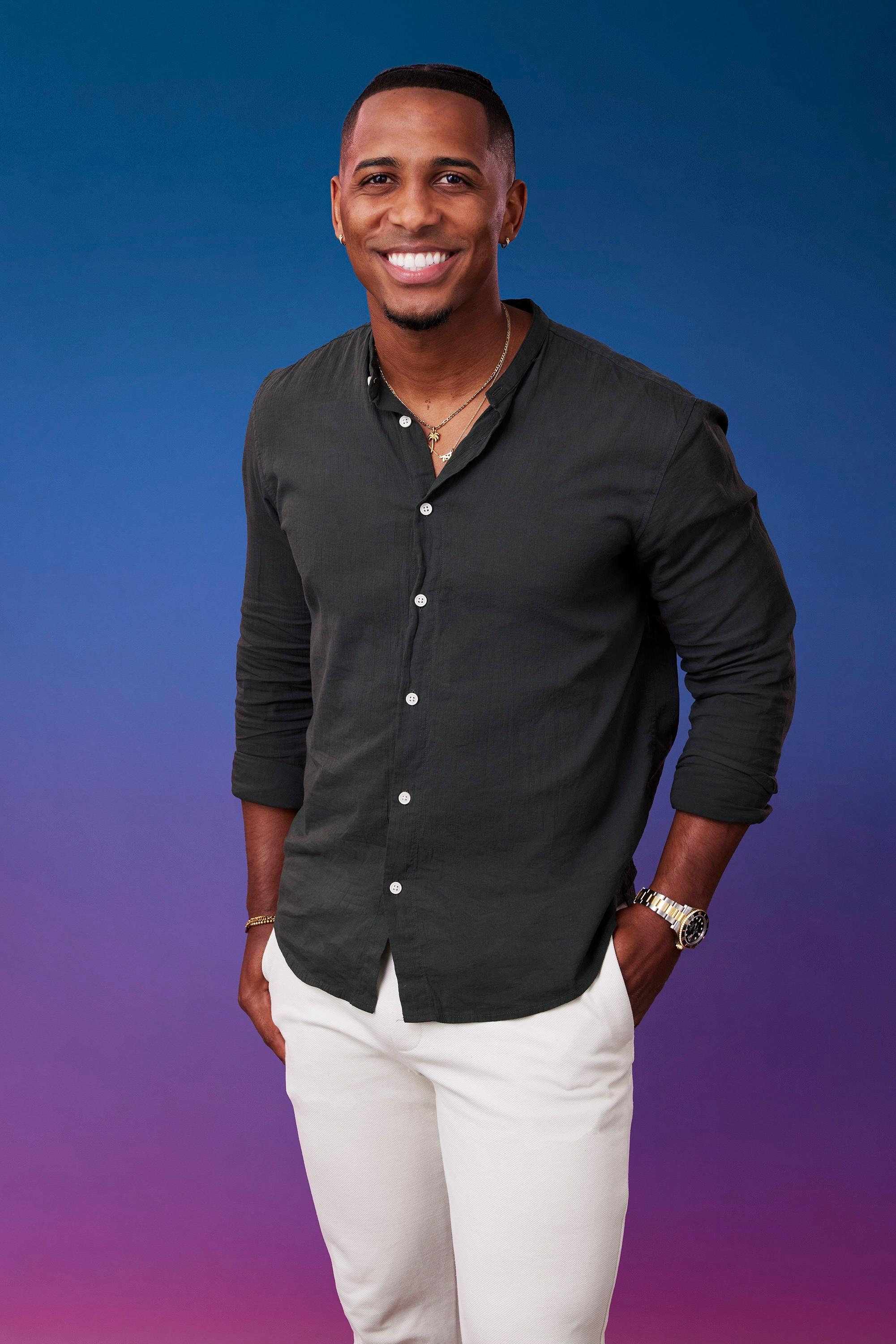 Ricky poses in front of a blue-purple ombré background for his official 'The Bachelorette' Season 21 portrait.