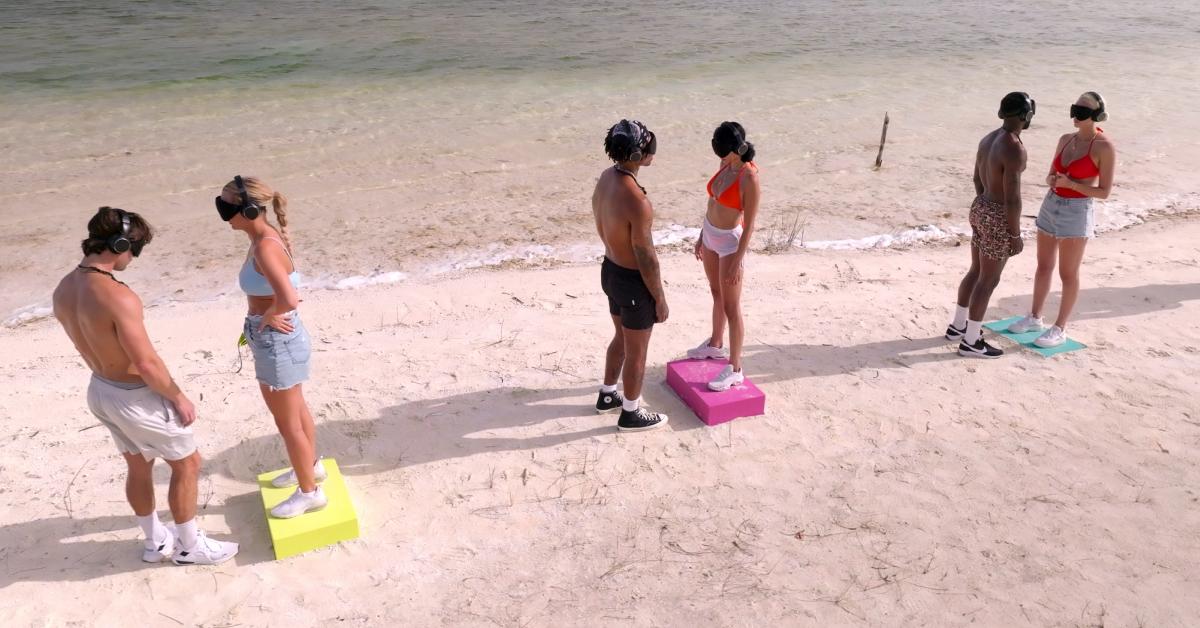 (L-R), Chris Hahn, Micah Lussier, Dom Gabriel, Xanthi Perdikomatis, Kaz Bishop, and Elys Hutchinson are blindfolded on the beach in 'Perfect Match' Season 2.