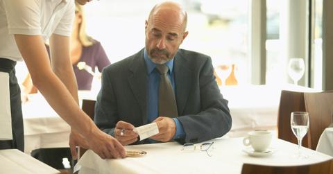 Man Checking Receipt with Server at Restaurant