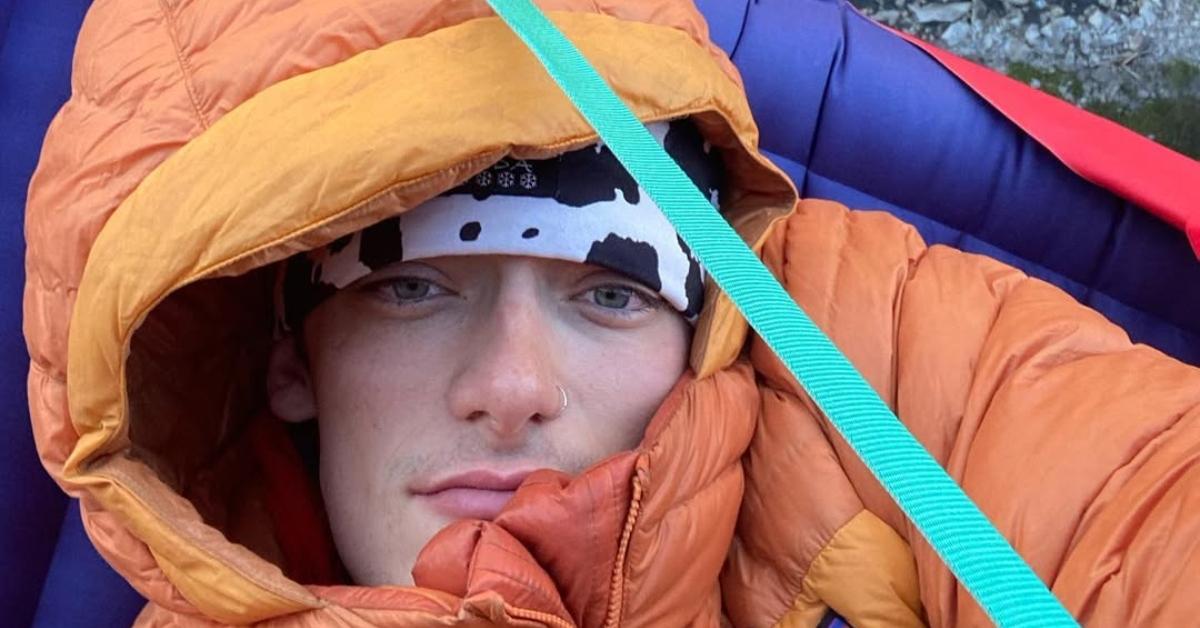 Balin Miller in a sleeping bag on the side of a mountain.