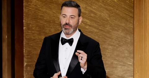 Jimmy Kimmel in a black suit and tie onstage at the 2023 Academy Awards