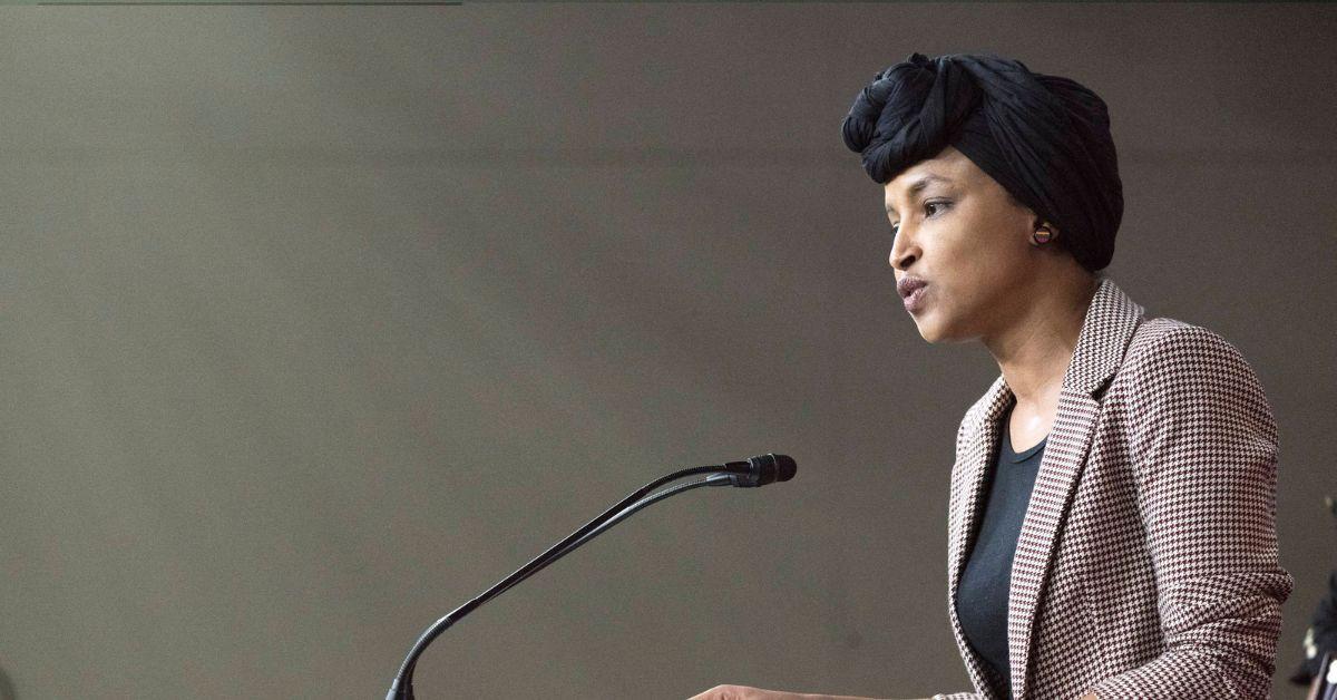 Ilhan Omar at a podium at a meeting of the Congressional Progressive Caucus. 