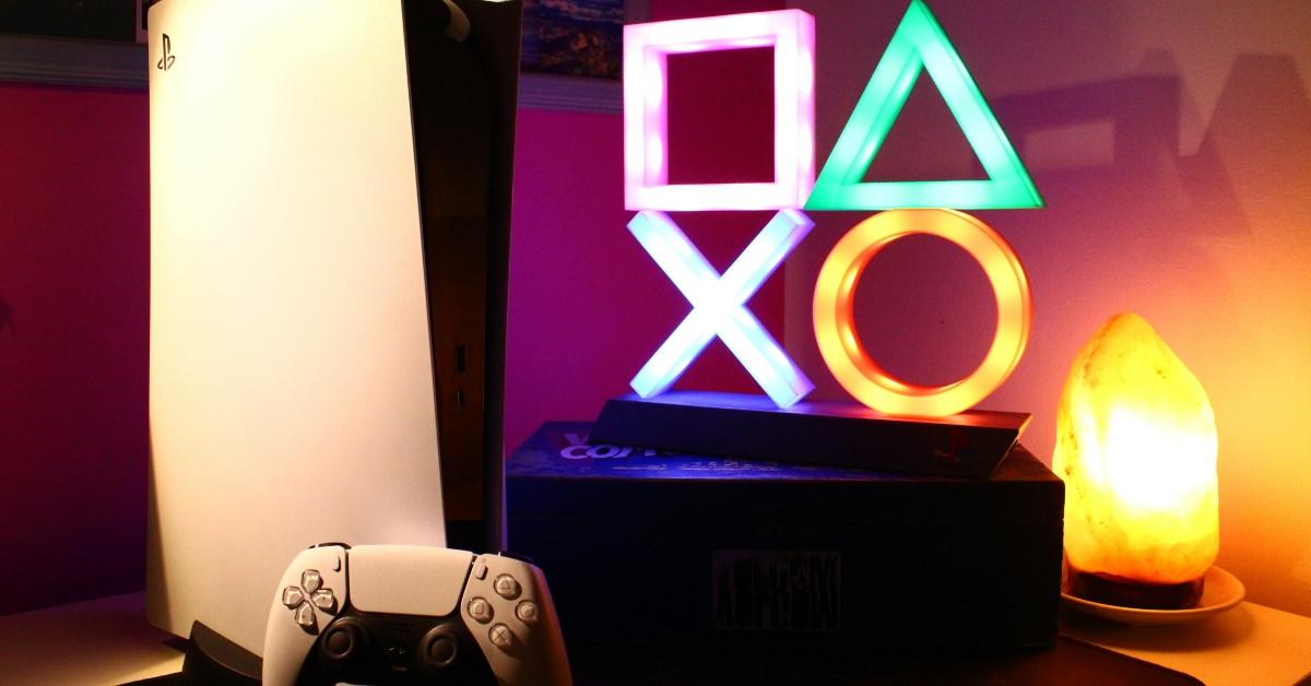 PlayStation console and controller in front of control pad symbols
