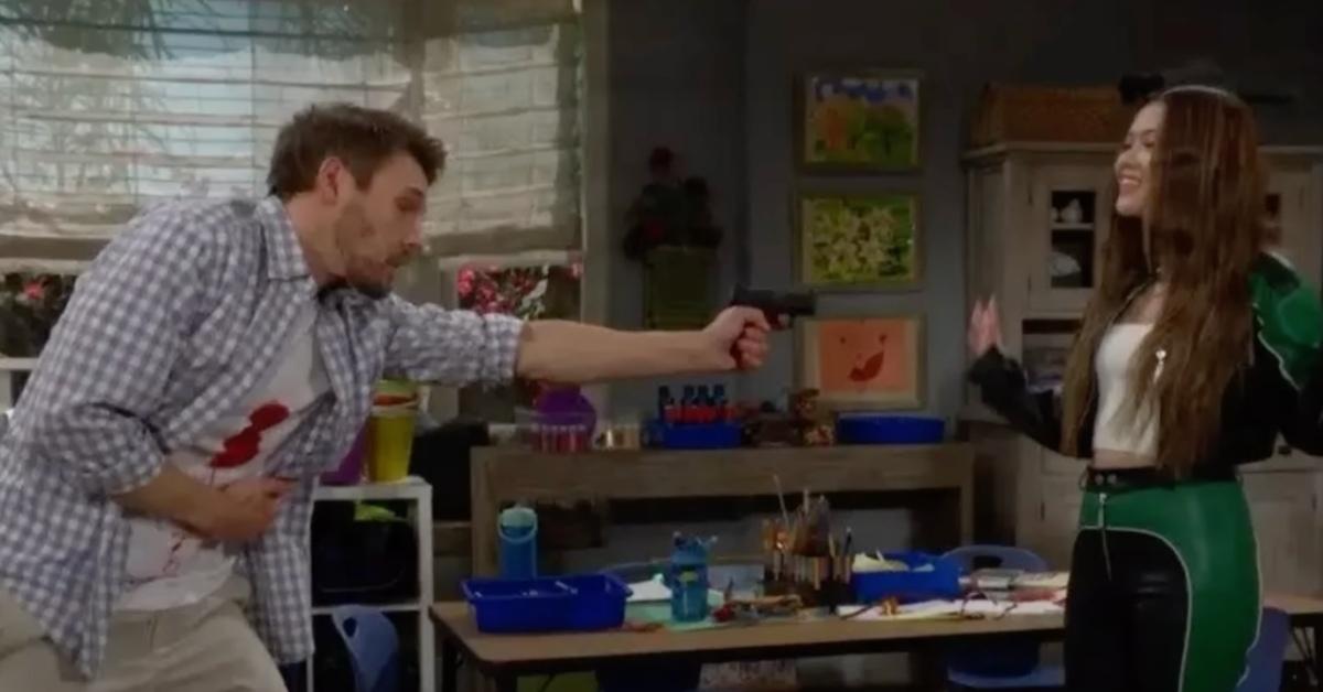 Liam pointing a gun at Luna.