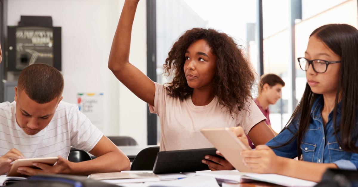 teenage schoolgirl raising hand in class picture id