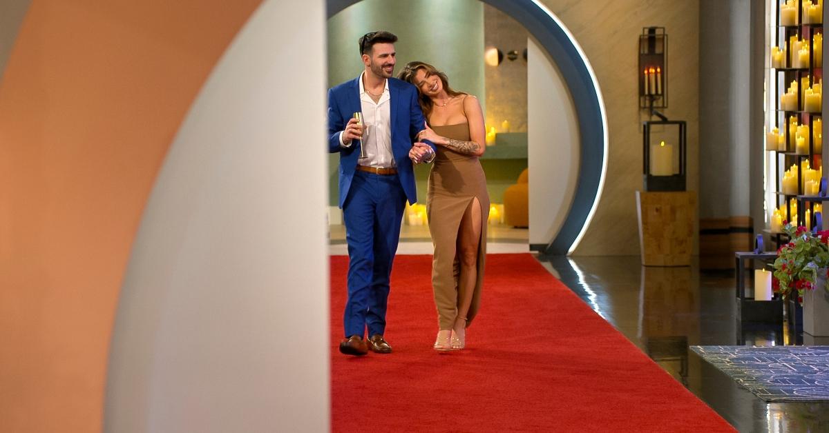 Ali and Anton from Love Is Blind walk together outside of the pods.