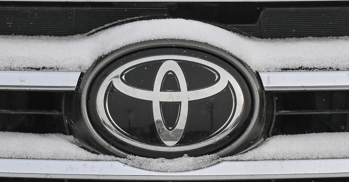 A Toyota logo surrounded by snow on a Fender. 