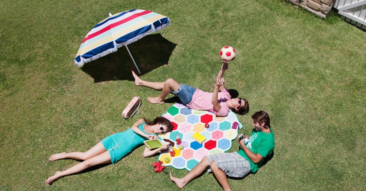 A group of teens reading in the summer.