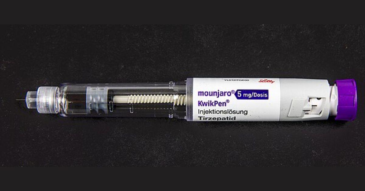 A Mounjaro vial on a black background.