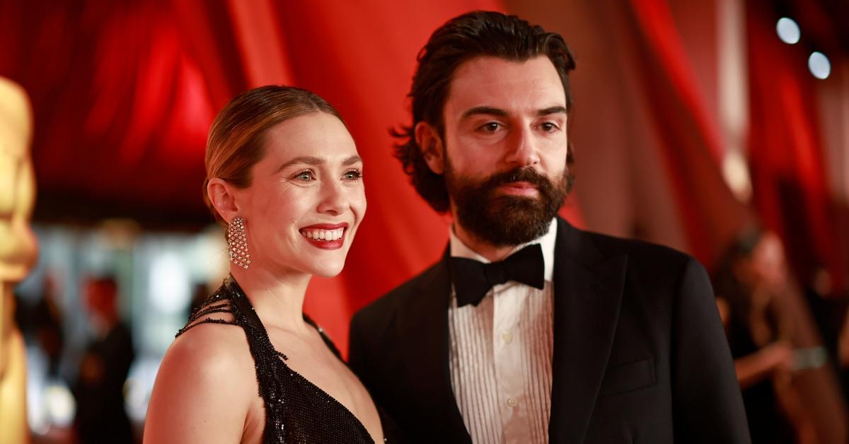 lizabeth Olsen and Robbie Arnett attend the 95th Annual Academy Awards on March 12, 2023 in Hollywood, California