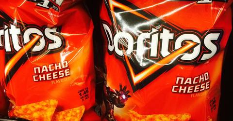 Bags of Nacho Cheese Doritos on a shelf.