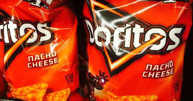 Bags of Nacho Cheese Doritos on a shelf.