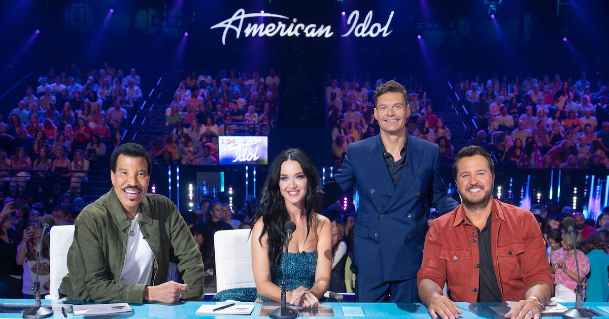 The 'American Idol' judges and host Ryan Seacrest pose in front of audience