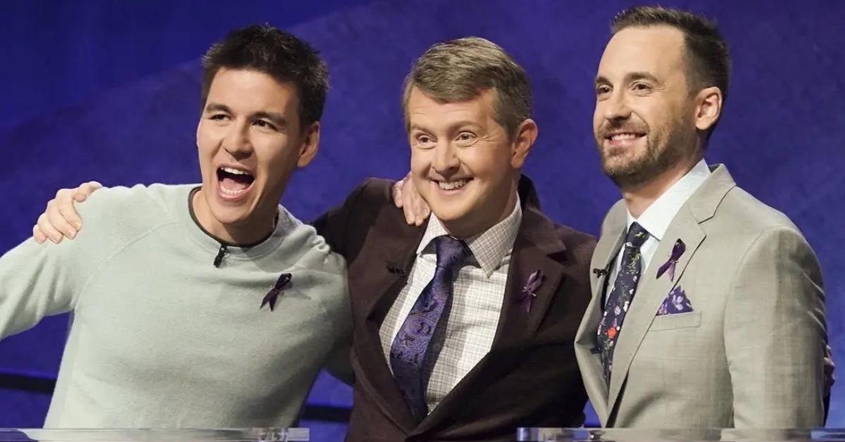 James Holzhauer (L), Ken Jennings (M), and another game show participant posing together.